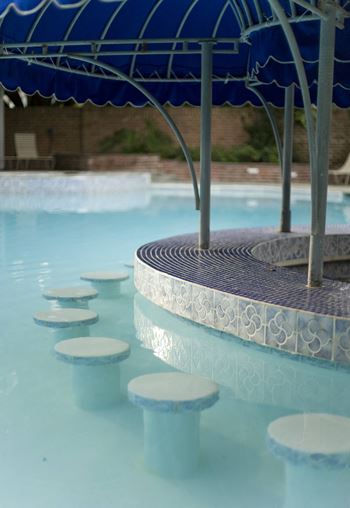 a row of stools in a swimming pool